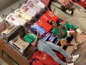 Bunch of girls in various outfits at a Cardinals baseball game