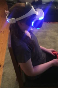 Candid Teen in White Socks And Yoga Pants Sitting With a VR Headset On