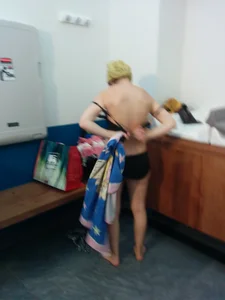 A couple of sexy girls in bikinis and lingerie in changing area