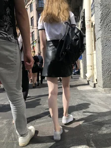 Hot redhead chick wearing leather skirt, nice pale legs