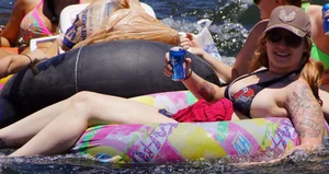 Sexy party girls in bikinis on a lake
