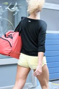 Blonde looking sexy walking in short yellow shorts