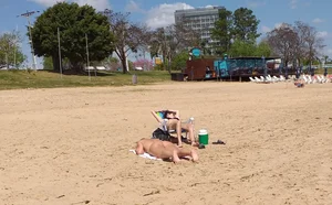 Girl laying out getting sun in a white thong bikini
