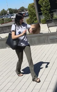 Brunette in yoga flare going up escalator