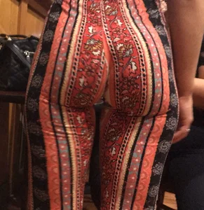 Big fat ass in pattern flare pants with some pokey pierced nipples in a blue crop top