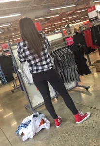 Cute Girl in Yoga Pants Bending Over at the Store