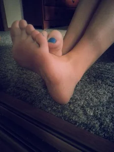 Feet With Blue Pedicure Closeup in the Mirror