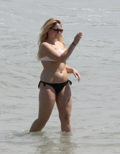 Big boobed thick blonde on the beach in a bikini