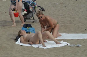 Topless girls on a beach in Barcelona