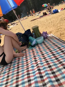 Skinny Girl in a Black Swimsuit at a Beach