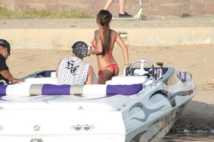 Brunette on a boat in red thong bikini with a tight little ass