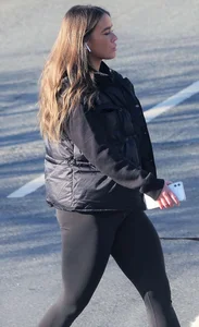 Pouting brunette teen in black leggings