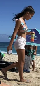 Beautiful brunette teen babe on the beach with a perfect body