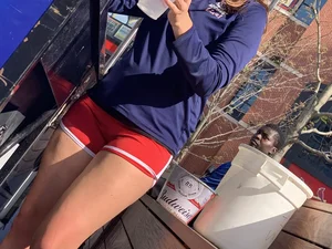 Bunch of girls in various outfits at a Cardinals baseball game