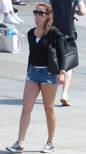 Cute girl with nice legs in short denim shorts