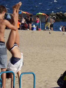 Beach teen in semi thong bikini under see through dress on the beach