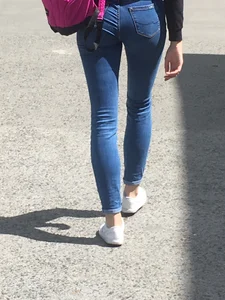 Girl in Tight Jeans Walking Down the City Park Candid
