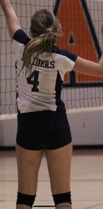 Teen girls playing volleyball