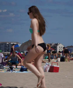 Sexy beach brunette in teal top and black bottom bikini