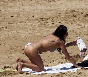 Sexy beach babe with silver bikini wedged into a thong and nice boobs