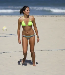 Hot girls playing beach volleyball in bikinis and shorts