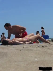 Purple thong topless lady on the beach gets oiled up by her husband