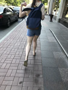 Girl with awesome pale legs in shorts wearing a backpack street creepshots