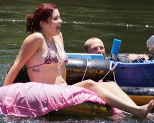 Sexy party girls in bikinis on a lake