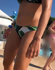 Blonde looking sexy in a green bikini at the pool
