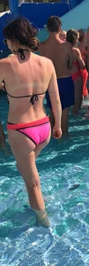 Sexy girl at the pool in pink bikini