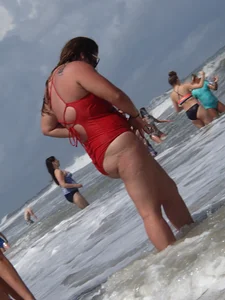 Fat chick on the beach in a red swimsuit