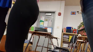 College blonde girl in a pink hoodie and leggings low angle creepshots in class