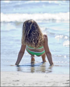 Super hot beach babe with a perfect body in a green thong bikini