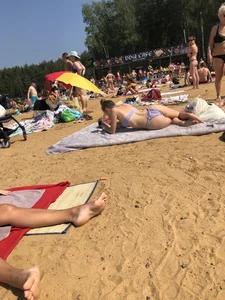 Candid Girl With Perfect Booty in a Hot Swimsuit Lying on a Towel at a Beach Photos