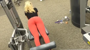 Very hot and sexy blonde at the gym working out in red leggings