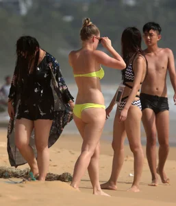 Big booty white girl in a yellow bikini at the beach