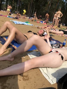 Candid Girls Lying on a Beach With Spread Legs Photos
