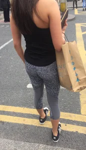 Sexy girl walking in grey patterned leggings with friend in tight jeans
