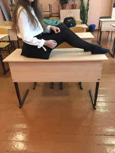 Young College Girl in Black Pantyhose, a Blouse And a Skirt in a Classroom Photos