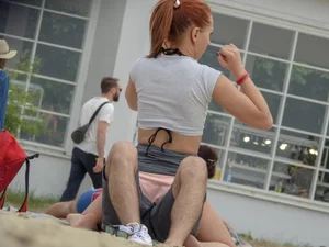 Beach babe with boyfriend upskirted showing her bikini underneath