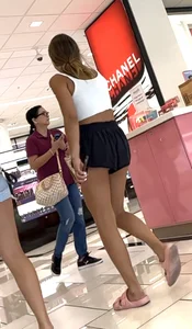 Cheeky short shorts blonde going up escalator