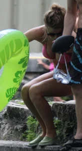 Blonde bikini girl at the pool in pink bikini top with amazing tits