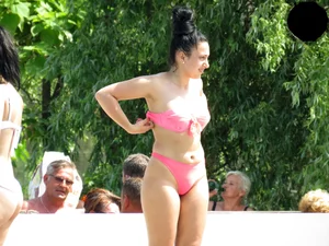 Smoking brunette in pink thong at the pool with camel toe