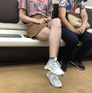 Amazing Hot Girl in a Skirt and Sneakers Sitting Cross-Legged in the Subway Train and on the Escalator Candid Photos Gallery