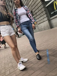 Hot Candid Girl in a Top, Shorts and Sneakers Skinny Legs Closeup Creepshots Gallery on the City Street