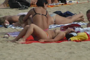 Topless girls on a beach in Barcelona