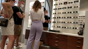 Cute optician helping out customers