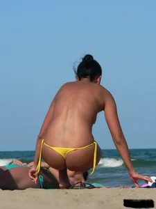Bunch of sexy babes on the beach topless and in thong bikinis