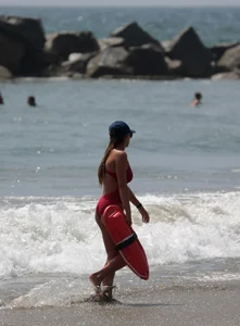 Two sexy lifeguards in red and blue swimsuits
