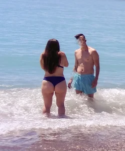 Thick lady at the beach in little blue bikini with big ass